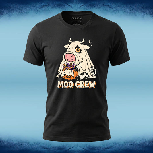 A black short-sleeve graphic t-shirt featuring a cartoon cow in a white ghost costume holding a pumpkin with purple candy, with the text 'MOO CREW' printed below. The shirt is displayed against a blue textured background.