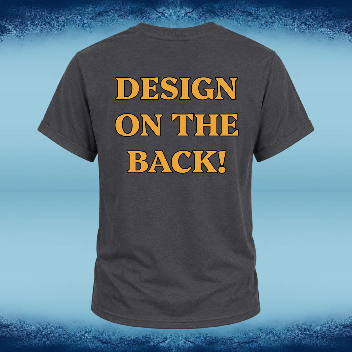 A dark gray t-shirt shown from the back, featuring the text 'DESIGN ON THE BACK!' printed in a bold yellow font with a black outline. The t-shirt is centered against a blue gradient background with a textured, cracked pattern at the top and bottom.