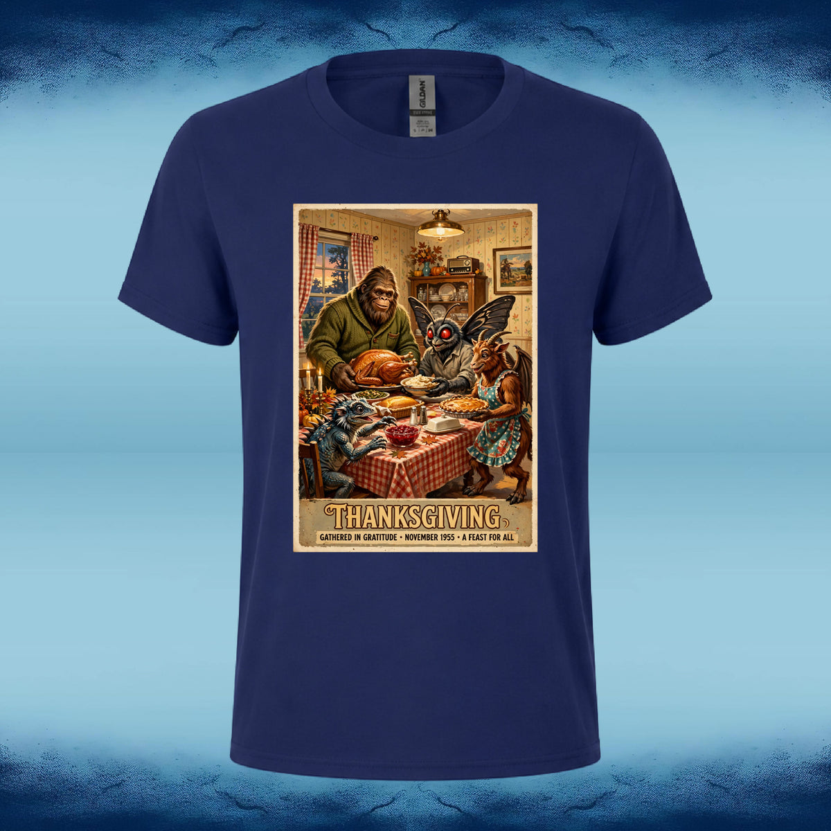 Navy blue crewneck graphic tee featuring Bigfoot, Mothman, and fellow cryptids gathered around a Thanksgiving dinner table.