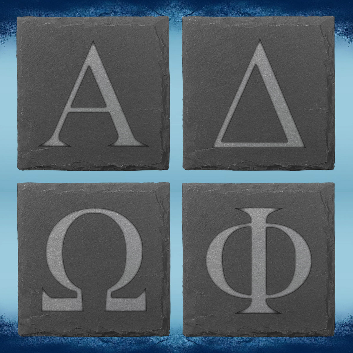 Four square dark gray stone coasters arranged in a 2x2 grid, each engraved with a large Greek letter: Alpha, Delta, Omega, and Phi, on a blue textured background.