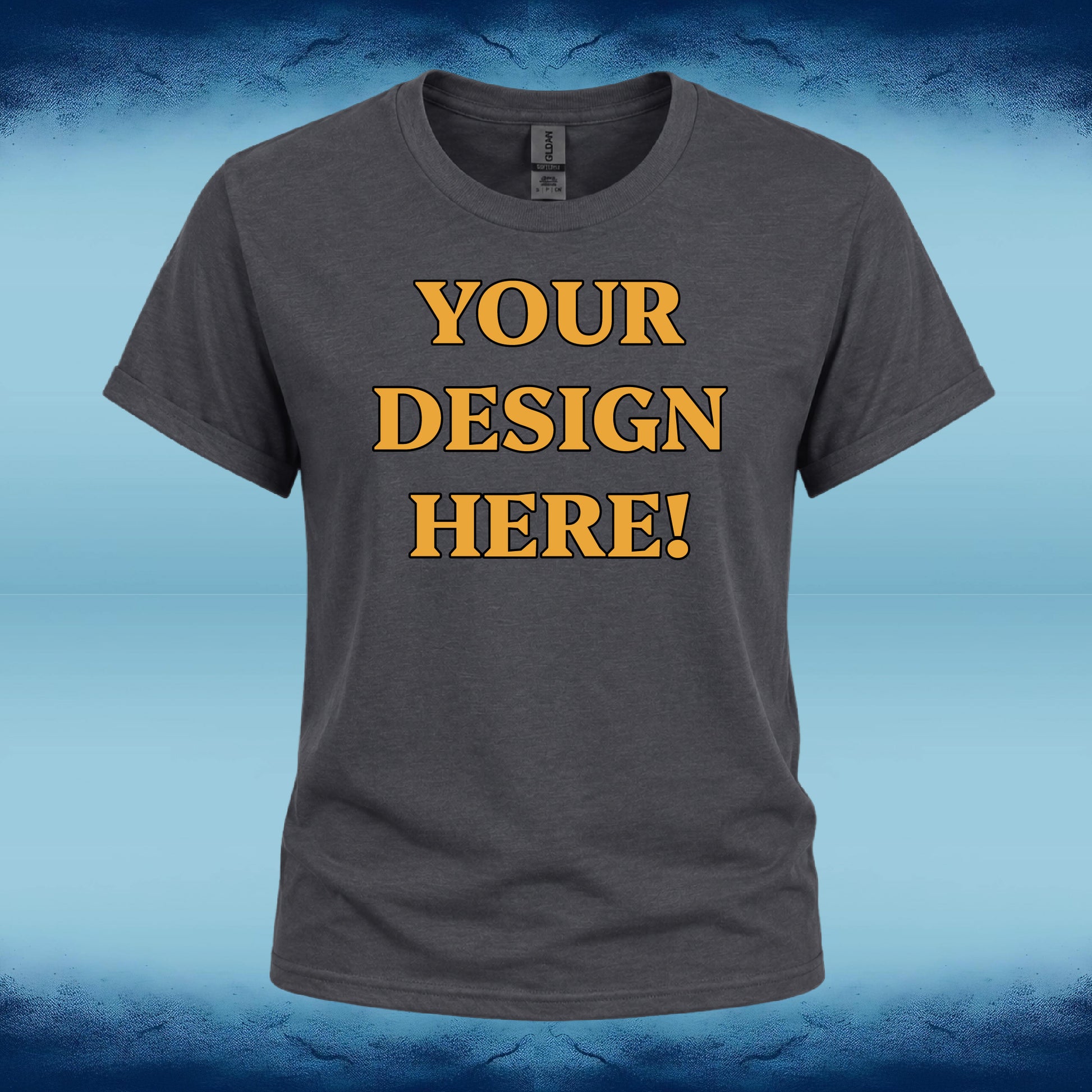 A dark gray heather t-shirt with 'YOUR DESIGN HERE!' printed in bold yellow letters with a black outline on the chest, displayed against a blue gradient background.