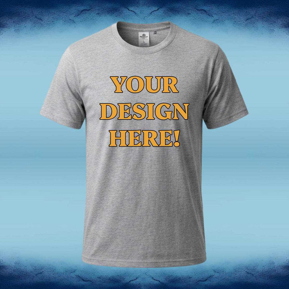 A heather gray short-sleeve t-shirt with 'YOUR DESIGN HERE!' printed in yellow block letters with a black outline on the chest, set against a blue gradient background.