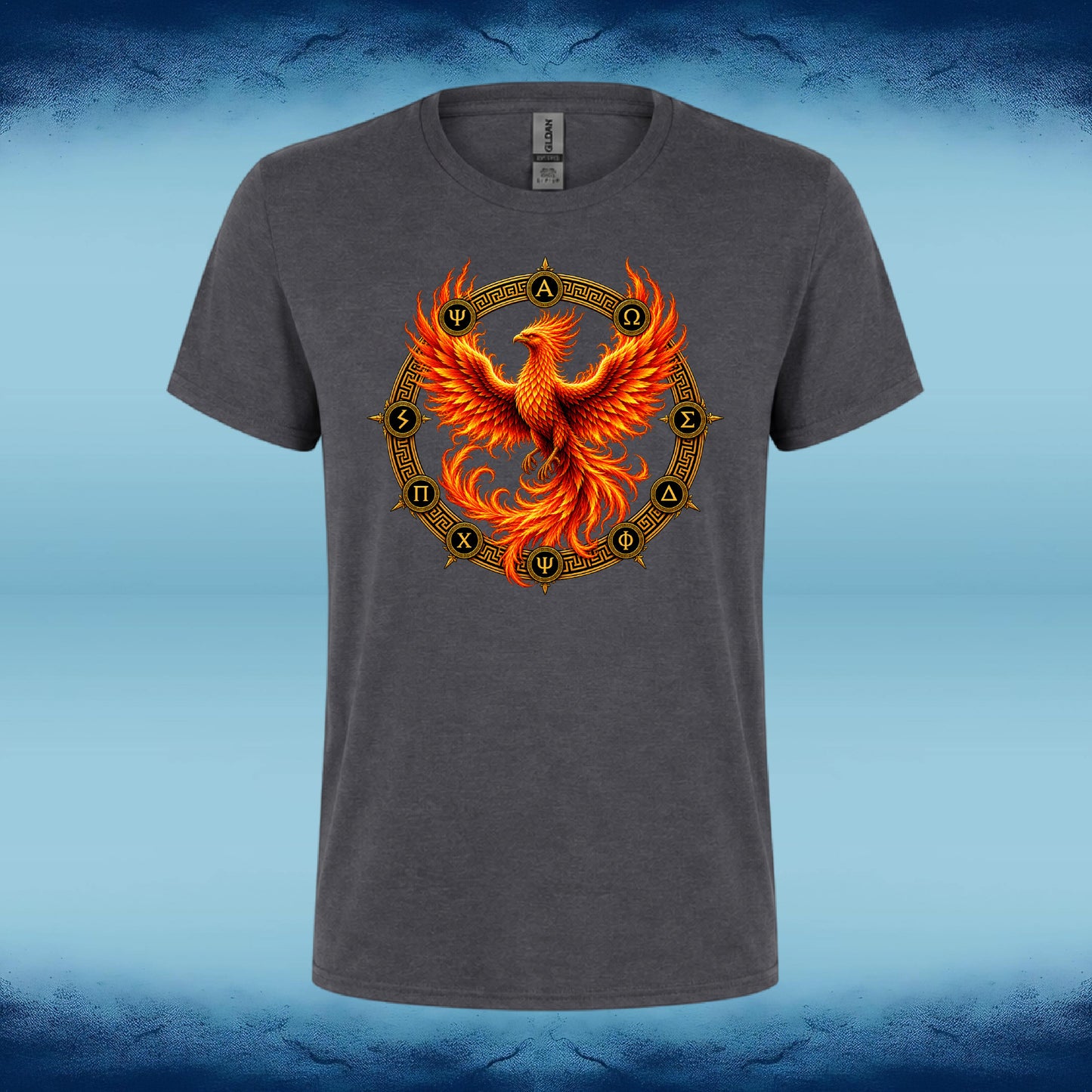 A dark gray heather crewneck t-shirt featuring a vibrant graphic of a fiery orange and yellow phoenix rising from a circular golden chakra wheel, set against a blue textured background.