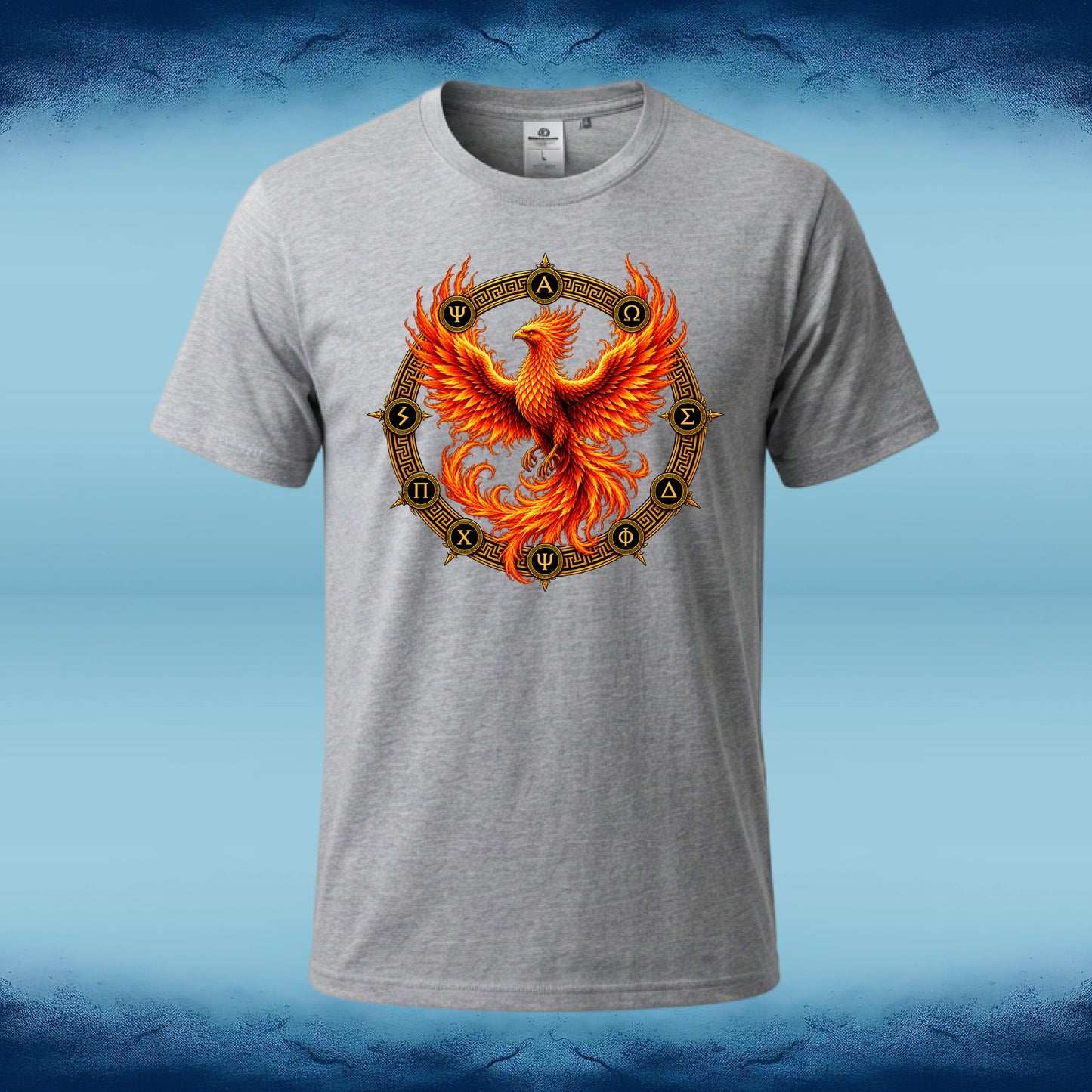 A heather gray short-sleeve t-shirt featuring a large graphic of a vibrant orange and yellow phoenix rising from a circular gold and black symbol, displayed on a blue gradient background.