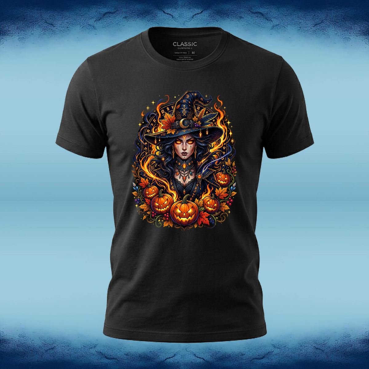 A black short-sleeve t-shirt with a detailed graphic of a witch surrounded by pumpkins and flames, displayed on a blue textured background.