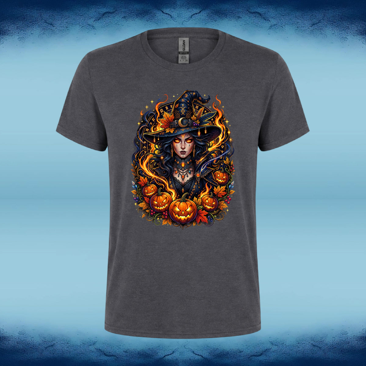 A dark gray heather crewneck t-shirt featuring a large, vibrant Halloween graphic of a witch surrounded by pumpkins and flames, set against a blue gradient background.