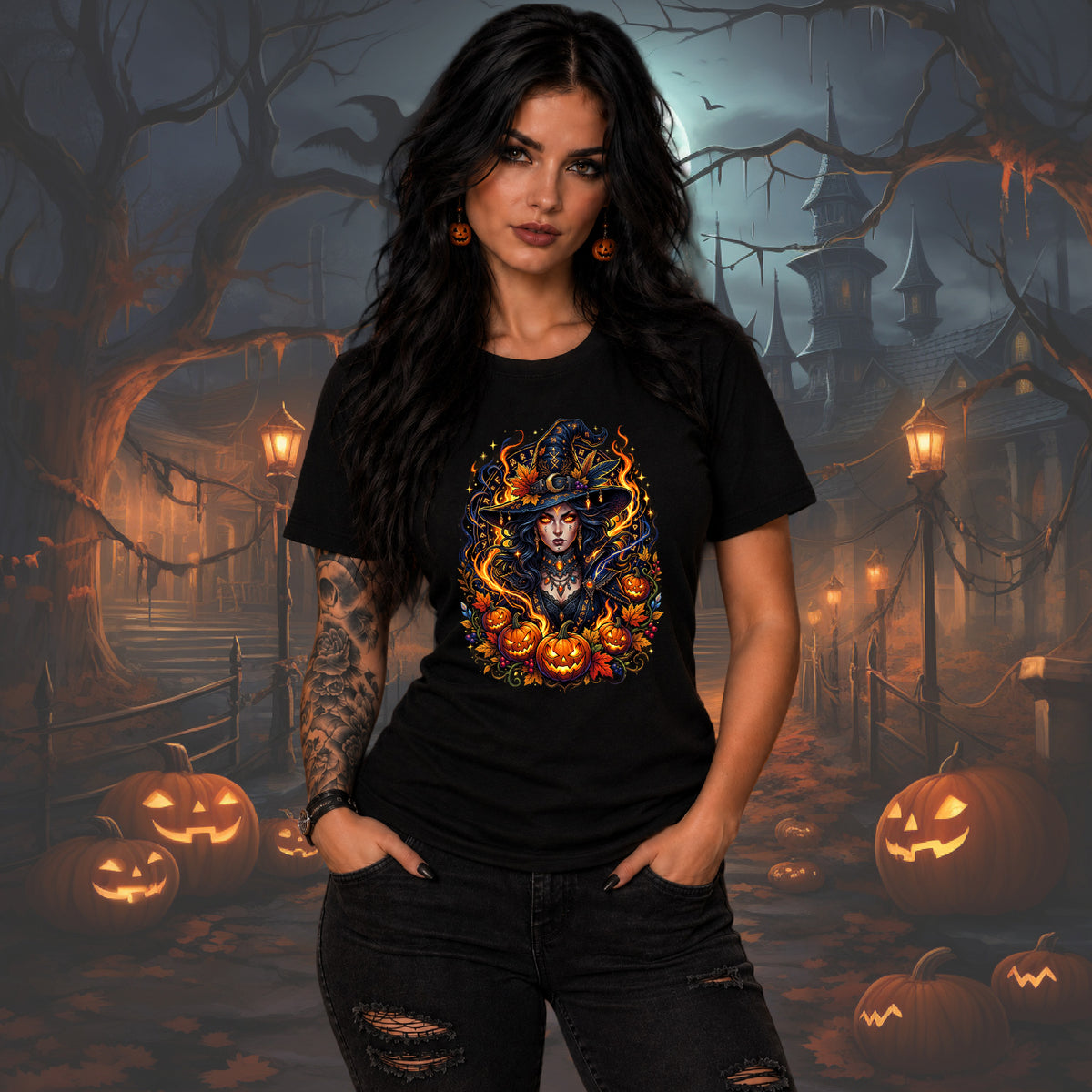 A woman modeling a black short-sleeve graphic t-shirt with a colorful witch and jack-o'-lantern design, set against a spooky Halloween-themed background with haunted houses, pumpkins, and bare trees.