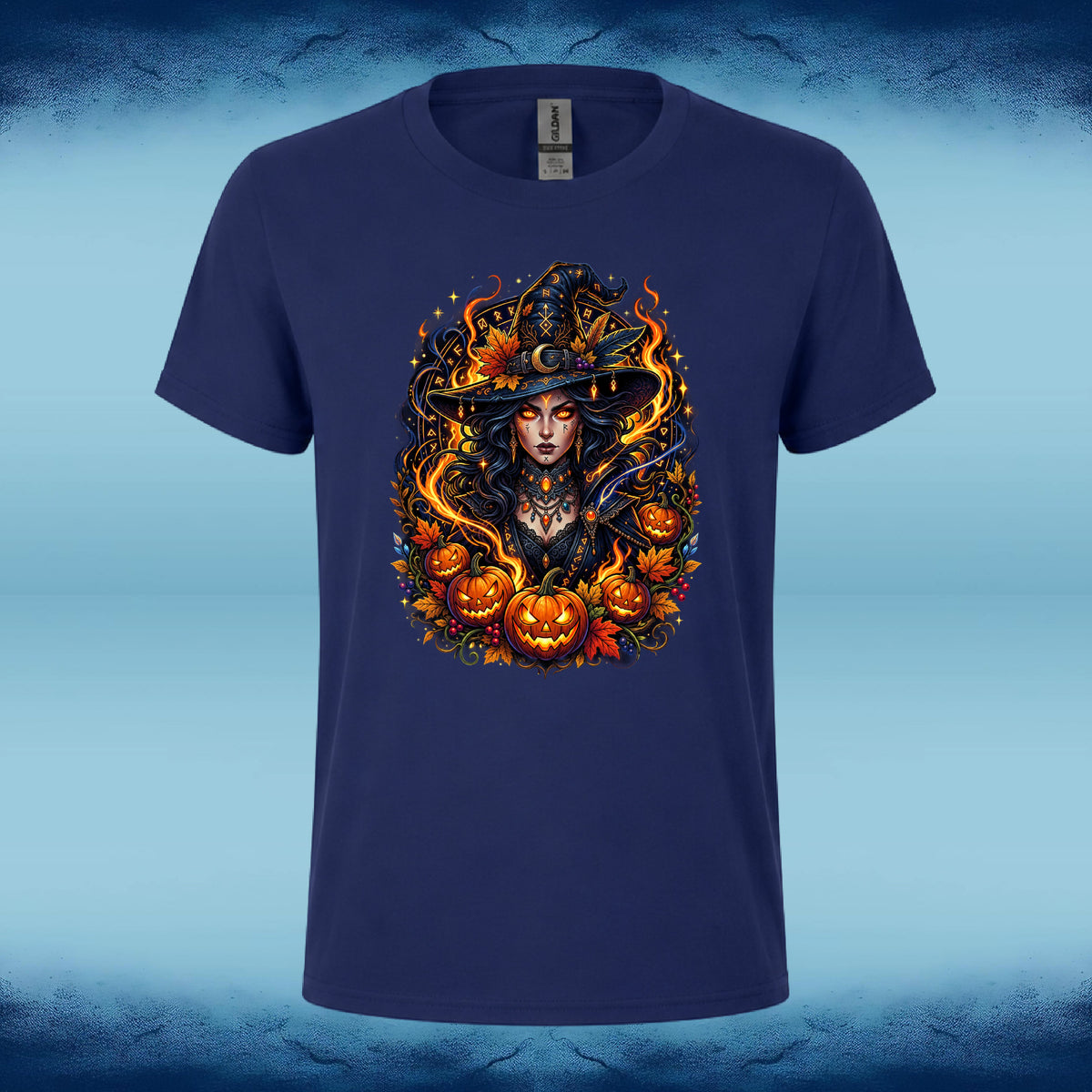 A navy blue short-sleeve t-shirt with a detailed Halloween graphic of a witch surrounded by pumpkins and flames, displayed against a blue textured background.