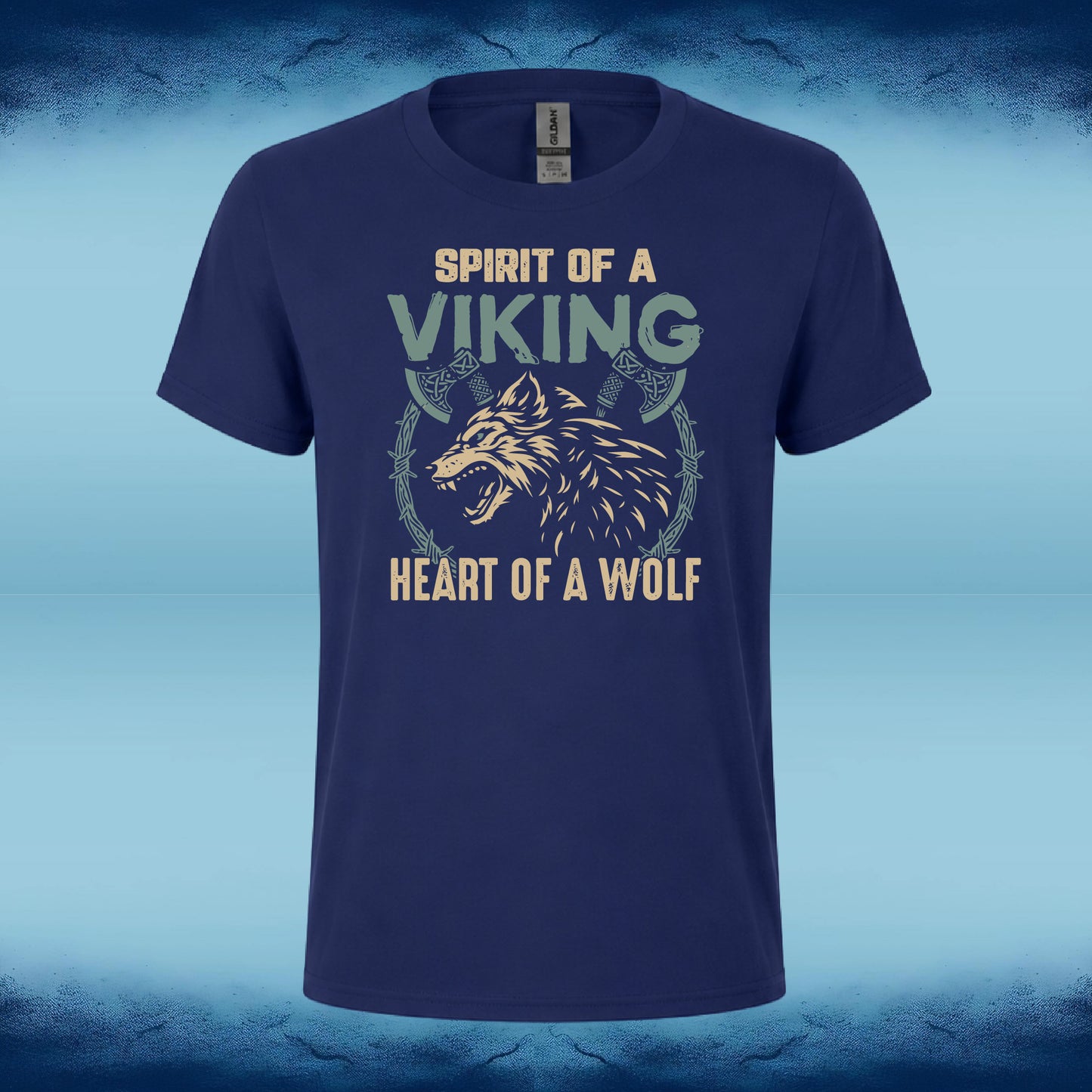 A navy blue short-sleeve t-shirt with a Viking-themed graphic print featuring a wolf and the text 'SPIRIT OF A VIKING' and 'HEART OF A WOLF' in beige and light green, displayed against a blue textured background.