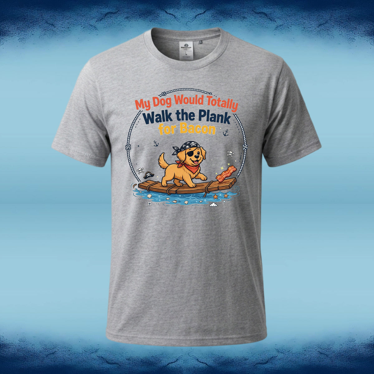 A heather gray short-sleeve t-shirt with a cartoon graphic of a golden retriever dog on a log holding a piece of bacon, with the text 'My Dog Would Totally Walk the Plank for Bacon'. The shirt is displayed against a blue gradient background.